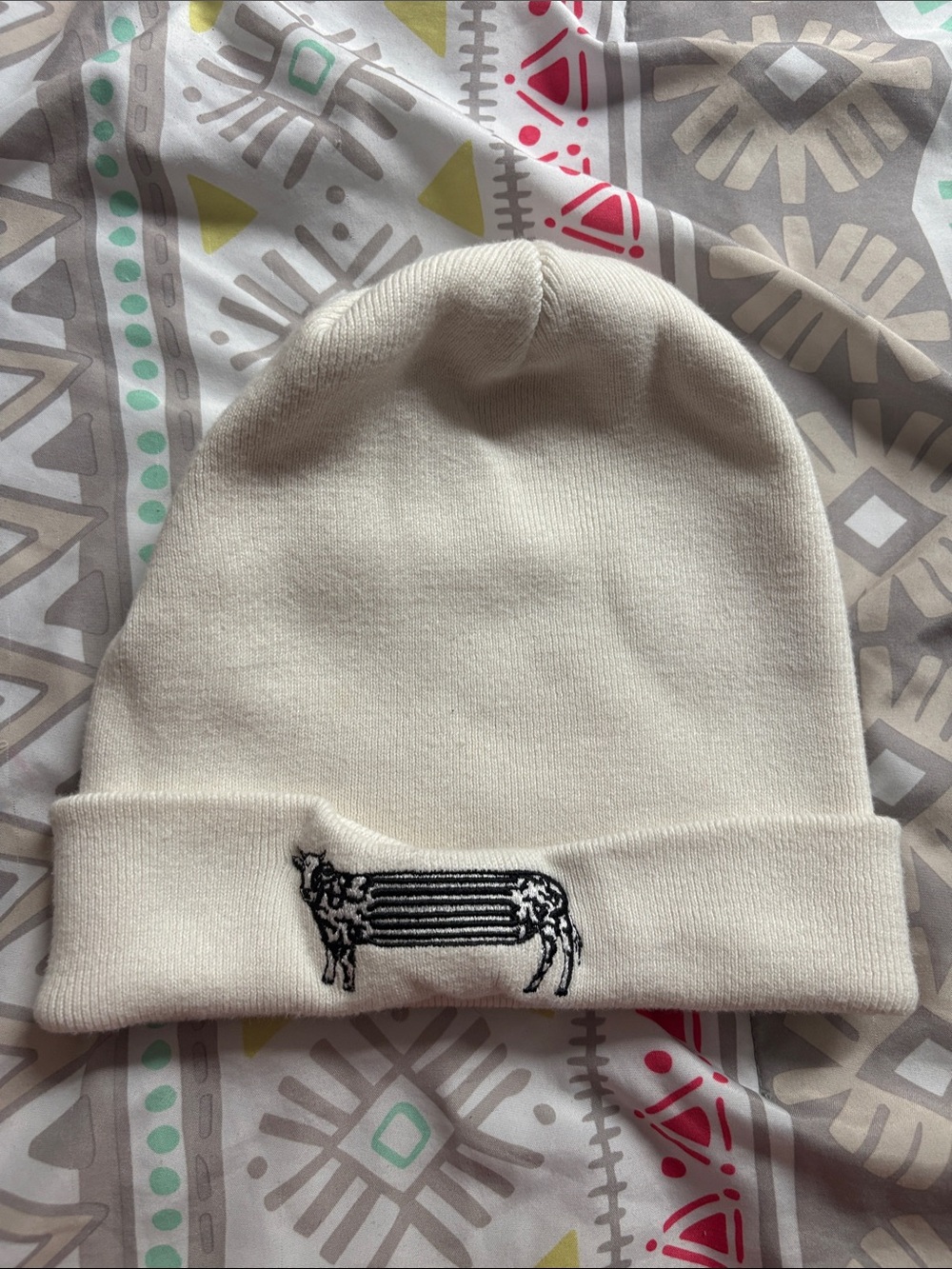 Omega Mart/Meow Wolf Cream Knit Beanie with Black Embroidered Cow